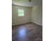 A light-filled bedroom with hardwood floors, a neutral paint, and a window at 608 Sharon Dr, Statesville, NC 28625