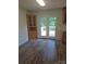 Open dining area with hardwood floors, a built-in hutch, and a door leading to the deck at 608 Sharon Dr, Statesville, NC 28625