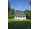 Charming home featuring a welcoming front porch with white railings and a well-maintained lawn at 608 Sharon Dr, Statesville, NC 28625