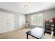 Bedroom with two closet doors, neutral carpet and walls, and a black table at 7151 Plough Dr, Mint Hill, NC 28227