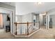 Upstairs hallway showcasing wood railing and neutral walls, connecting rooms and providing a welcoming flow at 7151 Plough Dr, Mint Hill, NC 28227