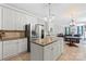 Open concept kitchen with stainless appliances, granite countertops, and white cabinets at 7151 Plough Dr, Mint Hill, NC 28227