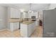 Spacious kitchen featuring granite countertops, tiled floors, stainless appliances, and white cabinetry at 7151 Plough Dr, Mint Hill, NC 28227