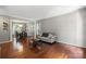 Spacious living room with hardwood floors, neutral color palette, and a view into the dining area at 7151 Plough Dr, Mint Hill, NC 28227