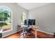 Bright office with large arched windows and hardwood floors, perfect for remote work at 7151 Plough Dr, Mint Hill, NC 28227