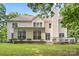 Exterior rear view of home with manicured landscaping and large windows at 7151 Plough Dr, Mint Hill, NC 28227