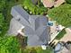 Birds-eye view of a home with manicured landscaping, patio, spa, and outdoor kitchen, creating an inviting backyard oasis at 8016 Pemswood St, Charlotte, NC 28277