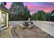 Paver patio features an outdoor kitchen, fireplace, hot tub, and seating, creating a relaxing outdoor entertainment space at 8016 Pemswood St, Charlotte, NC 28277