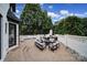 Paver patio features an outdoor kitchen, fireplace, hot tub, and outdoor seating, creating a relaxing entertainment space at 8016 Pemswood St, Charlotte, NC 28277
