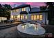 Back of house showcasing a spa with a fountain, with outdoor seating on the patio making the space great for entertaining at 8016 Pemswood St, Charlotte, NC 28277
