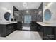 Modern bathroom featuring a double vanity, sleek mirrors, and walk-in shower at 8016 Pemswood St, Charlotte, NC 28277