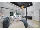 Bright bedroom featuring a four-poster bed, natural light, and view of the backyard at 8016 Pemswood St, Charlotte, NC 28277