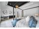 Bright bedroom boasts a four-poster bed, modern light fixture and stylish decor at 8016 Pemswood St, Charlotte, NC 28277