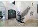 Grand entryway with hardwood floors, staircase, large windows, and modern design at 8016 Pemswood St, Charlotte, NC 28277
