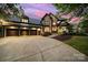 Beautiful exterior of a home featuring a stone facade, three-car garage, and well-maintained landscaping at 8016 Pemswood St, Charlotte, NC 28277
