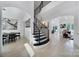 Bright and airy home foyer featuring hardwood floors, an open staircase, and views of adjacent living spaces at 8016 Pemswood St, Charlotte, NC 28277