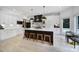 Modern kitchen with black island, pendant lighting, and stainless steel appliances at 8016 Pemswood St, Charlotte, NC 28277