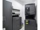 Well-organized laundry room with stackable washer/dryer, storage cabinets and modern design at 8016 Pemswood St, Charlotte, NC 28277