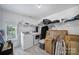 Bright laundry room with modern washer and dryer, storage shelves, and a window at 8016 Pemswood St, Charlotte, NC 28277