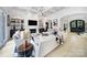 Open living room with modern light fixture, white sofa, and access to entry way at 8016 Pemswood St, Charlotte, NC 28277