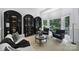Stylish living room with a cozy sofa, modern furniture, large windows, and elegant display cases at 8016 Pemswood St, Charlotte, NC 28277