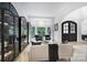 Cozy living room features comfortable seating, elegant built-in display cases, and ample natural light at 8016 Pemswood St, Charlotte, NC 28277