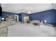 Large living room with blue walls, stylish furniture, arched doorway and ample lighting at 8016 Pemswood St, Charlotte, NC 28277
