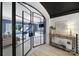 Open living room with glass doors, stylish furniture, neutral colors, and backyard view at 8016 Pemswood St, Charlotte, NC 28277