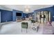 Bright, blue office with modern lighting, hardwood desk, lounge area, and steel-framed glass doors at 8016 Pemswood St, Charlotte, NC 28277