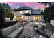 Back of house showing patio with spa, outdoor seating, and a view of the main bedroom; great for relaxing and entertaining at 8016 Pemswood St, Charlotte, NC 28277