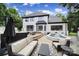 White brick home with a covered patio, spa, and outdoor seating provides space for relaxing and enjoying the backyard at 8016 Pemswood St, Charlotte, NC 28277