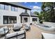 Well maintained white brick house with black trim, a patio, spa, and outdoor seating, perfect for outdoor living at 8016 Pemswood St, Charlotte, NC 28277
