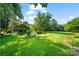 Lush, sprawling backyard with mature trees and landscaped gardens, offering a private oasis at 8900 Cumbria Ct, Huntersville, NC 28078