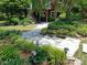 Stone patio and landscaped garden with lush plants and walkway create a serene outdoor space at 8900 Cumbria Ct, Huntersville, NC 28078