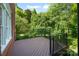 Back deck featuring metal railings, stairs, and lush foliage views at 8900 Cumbria Ct, Huntersville, NC 28078