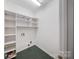 Practical laundry room with built-in shelving, providing ample storage for organization and convenience at 8900 Cumbria Ct, Huntersville, NC 28078