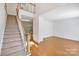 Spacious living area boasts hardwood floors, staircase, and neutral walls at 8900 Cumbria Ct, Huntersville, NC 28078