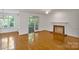 Living room featuring hardwood floors, fireplace, and natural light streaming in from the back door at 8900 Cumbria Ct, Huntersville, NC 28078
