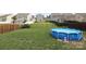 Large backyard with a well-maintained lawn, black fence, and above-ground pool, perfect for outdoor recreation at 903 Von Buren Blvd, Rock Hill, SC 29730