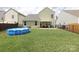 Spacious backyard with green grass, an above-ground pool, and covered patio at 903 Von Buren Blvd, Rock Hill, SC 29730