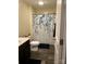 Cozy bathroom featuring a shower with a blue-leaf pattern curtain and dark wood-look flooring at 903 Von Buren Blvd, Rock Hill, SC 29730