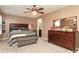 Cozy bedroom features a ceiling fan, carpet flooring, and a large dresser with mirror at 903 Von Buren Blvd, Rock Hill, SC 29730