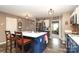 Bright kitchen features an island with breakfast bar seating, stainless steel appliances and dark wood flooring at 903 Von Buren Blvd, Rock Hill, SC 29730