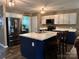 Spacious kitchen with stainless steel appliances, island with seating, and stylish countertops at 903 Von Buren Blvd, Rock Hill, SC 29730