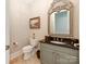 Elegant powder room features a designer mirror, granite countertop and stylish fixtures at 9730 White Frost Rd, Charlotte, NC 28277