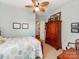 Comfortable bedroom features a ceiling fan and a warm-toned, decorative wooden bed frame at 9730 White Frost Rd, Charlotte, NC 28277