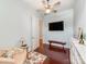 Cozy bedroom featuring a ceiling fan, a wall-mounted TV, and cherry hardwood flooring at 9730 White Frost Rd, Charlotte, NC 28277