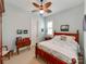 Comfortable bedroom features a ceiling fan and a warm-toned, decorative wooden bed frame at 9730 White Frost Rd, Charlotte, NC 28277
