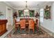 Formal dining room featuring a large wood table, leather chairs, and elegant lighting fixtures at 9730 White Frost Rd, Charlotte, NC 28277