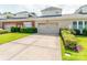 Attached home with a two-car garage, flower bed and a neatly kept lawn at 9730 White Frost Rd, Charlotte, NC 28277
